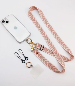 Detail of pink leaf-pattern woven phone strap with gold clasp and pearl charm accessories