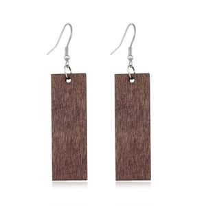 Close-up of rectangular dark wood hollow earrings with silver hooks on white background