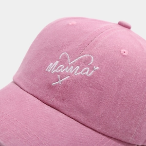 Detailed close-up of Mama embroidery and twill texture on a pink washed cotton cap
