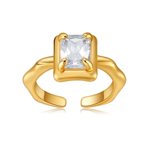 Detail of gold open ring featuring large rectangular zircon and wavy textured band