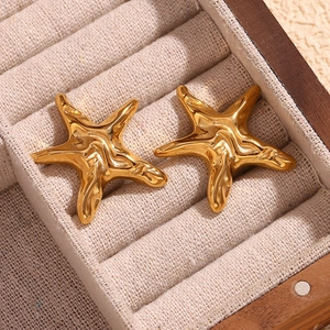 Detailed close-up of golden starfish stud earrings with liquid metal texture in a box