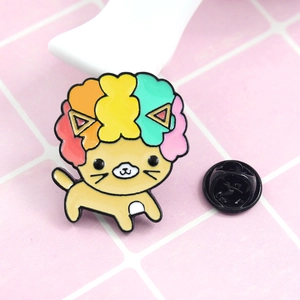 Macro detail of cute enamel lion brooch with colorful rainbow mane and black butterfly clutch