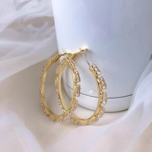 Elegant gold C-shaped hoop earrings featuring sparkling clear rectangular cubic zirconia