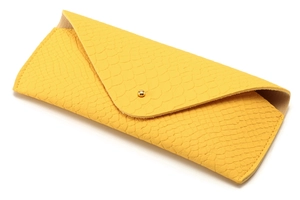 Detail of yellow snakeskin leather glasses case with a gold snap button closure
