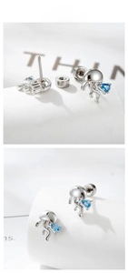 Detailed view of silver jellyfish stud earrings with blue teardrop zircon gemstones
