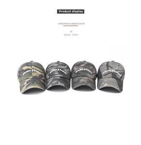 Detail view of four washed camouflage baseball caps with Adventure & Freedom embroidery