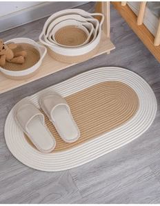 Close-up of Japanese style braided oval cotton rug texture and natural beige fibers