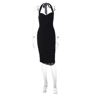 Detailed close-up of a black ruched bodycon dress with halter neckline and elastic fabric