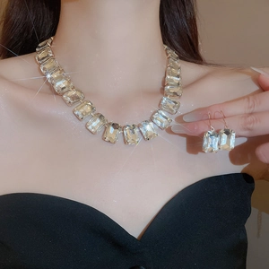 Detailed view of luxury square crystal jewelry set with silver fringe on elegant model