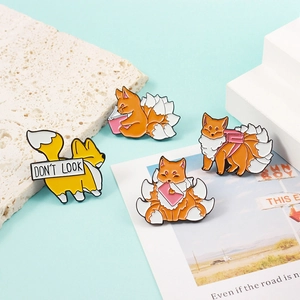 Cartoon enamel fox brooch set with cute nine-tailed fox designs on a blue background