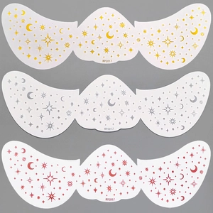 Detailed view of gold, silver, and red star and moon freckle tattoo stickers for face makeup