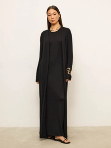Elegant black knit long dress and cardigan set with golden snake choker on model