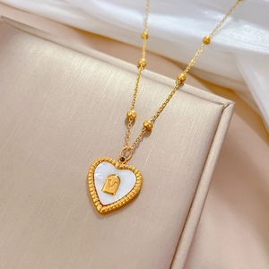 Minimalist gold titanium steel heart necklace with shell inlay and V-shaped detail