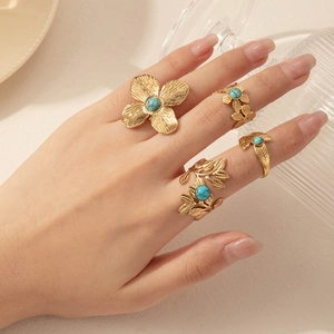 Adjustable gold stainless steel flower and leaf rings set with turquoise stones