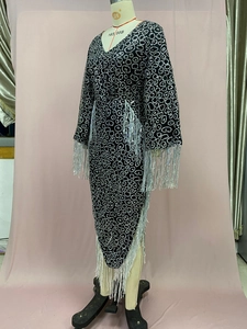 Detail of V-neck sequined dress with silver rings and long fringe tassels on sleeves