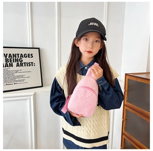 Detailed close-up of a pink plush kids crossbody bag showing soft texture and strap