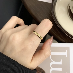 Close-up of minimalist 18K gold plated celestial star ring with a small diamond detail