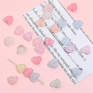 Macro shot of colorful translucent heart-shaped acrylic beads with ice-crack texture