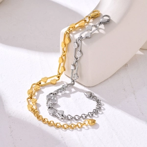 Detail of interlocking heart chain links on polished stainless steel bracelet with lobster clasp