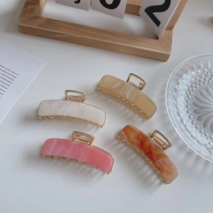 Set of four 7.5cm rectangle acetate claw clips in cream, pink and amber marble textures