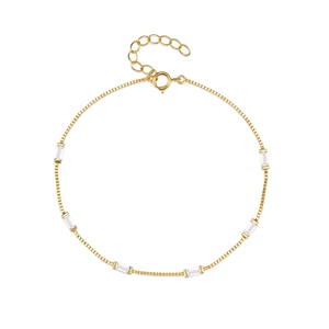 Macro shot of 18K gold box chain bracelet with six rectangular clear zircons