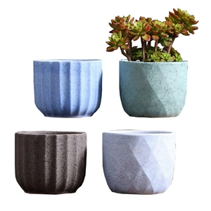 Set of four textured ceramic succulent pots in blue and grey with ribbed and geometric designs