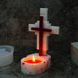 Gothic cross candle holder mold with red splatter effect and burning tea light candle