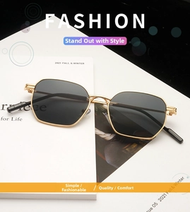 Detail view of gold metal frame sunglasses legs with printed size specifications