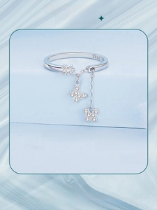 Macro detail of S925 sterling silver butterfly tassel ring with fine chain and sparkling zircons