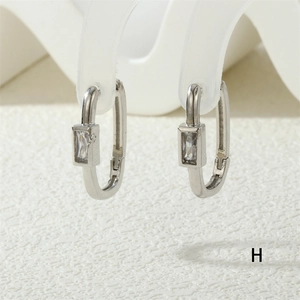 Macro detail of silver rectangular zircon earrings showing precision metalwork and stone setting