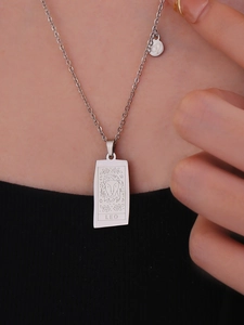 Detailed view of silver Leo zodiac square pendant necklace worn by a model