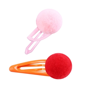 Detail of colorful plush pom-pom hair clips for girls with pink and orange metal BB pins