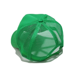 Detail of adjustable snapback closure and green mesh panels on a stylish trucker cap