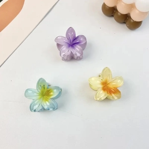 Detailed view of three 4cm translucent candy-colored flower hair clips in various pastel tones