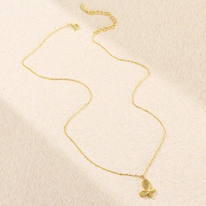 Macro shot of gold butterfly pendant with radial texture and adjustable extension chain