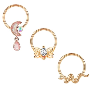 Detail of rose gold nose rings set featuring moon, butterfly, and snake charms