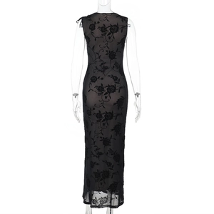 Detailed view of the rose flocked mesh fabric and textured pattern of the black dress