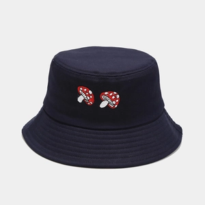 Detail of navy cotton bucket hat featuring twin red mushroom embroidery and stitched brim