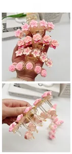Detail of pink resin flowers on a transparent hair claw clip with floral decorations