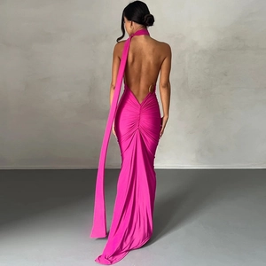 Detail of backless fuchsia evening gown with waist metal ring and elegant draping