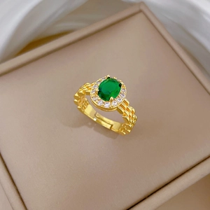 Gold-plated watch link ring featuring an oval emerald and white diamond halo