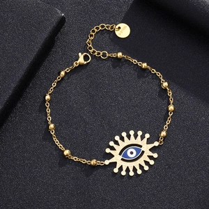Detail of gold stainless steel chain with evil eye charm and s-steel engraving