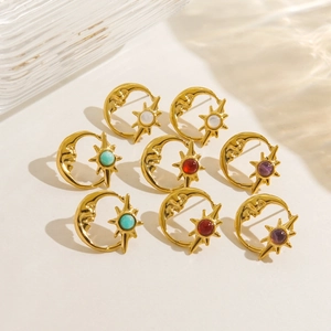 Detailed shot of vintage gold sun and moon earrings with turquoise and ruby stones