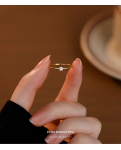 Detail of s925 gold-plated silver ring with brilliant round white zircon setting
