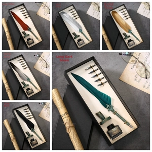 Detailed set of vintage feather quill pen with five nibs, holder and ink in antique style