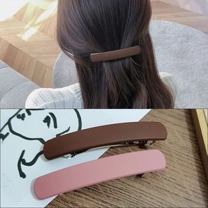 Minimalist matte hair clip for women featuring long spring design in brown and pink colors
