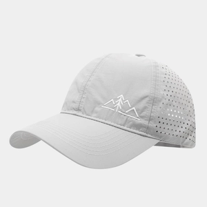 Close-up of light grey baseball cap with mountain embroidery and laser-cut mesh vents