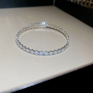 Macro shot of silver bangle featuring full row of sparkling rectangular cubic zirconia