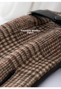Detailed macro view of textured British plaid woolen fabric and premium leather strap
