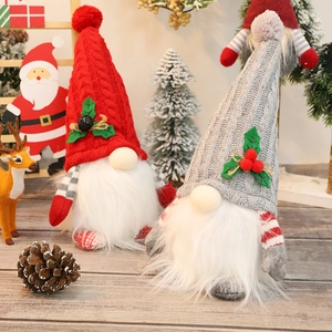 Lighted Christmas gnome plush with knitted hats and glowing Rudolf noses on wood
